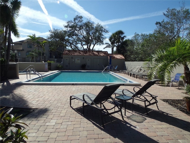 community pool featuring a patio and fence