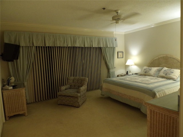 bedroom with carpet floors, ornamental molding, and a ceiling fan