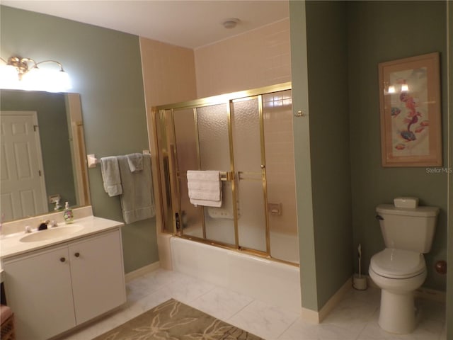 full bathroom with marble finish floor, toilet, enclosed tub / shower combo, vanity, and baseboards