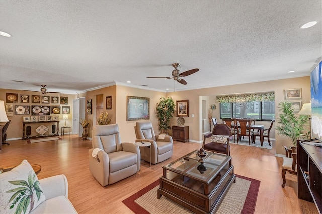 8140 Terrace Garden Dr N Unit 103, Saint Petersburg, FL 33709 - living area featuring ceiling fan, a textured ceiling, light wood finished floors, crown molding, and recessed lighting