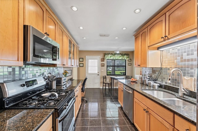 8140 Terrace Garden Dr N Unit 103, Saint Petersburg, FL 33709 - kitchen with appliances with stainless steel finishes, a sink, recessed lighting, backsplash, and baseboards