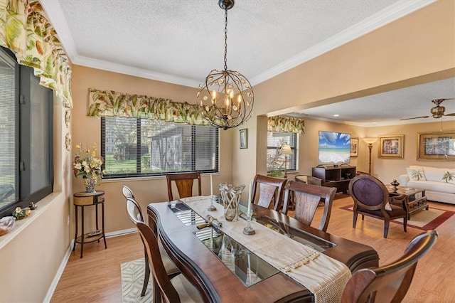 8140 Terrace Garden Dr N Unit 103, Saint Petersburg, FL 33709 - dining space featuring a textured ceiling, wood finished floors, a chandelier, crown molding, and baseboards