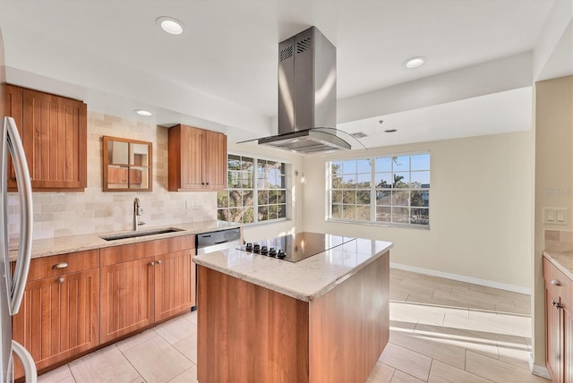 kitchen with light stone counters, backsplash, a sink, black electric stovetop, and island exhaust hood