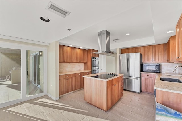 kitchen with tasteful backsplash, island exhaust hood, a kitchen island, a sink, and black appliances