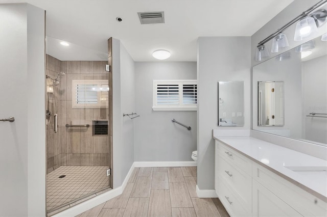 full bath with a shower stall, visible vents, toilet, and vanity
