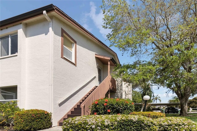 view of side of home with stucco siding