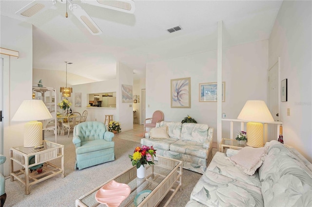 carpeted living area with vaulted ceiling, a ceiling fan, and visible vents