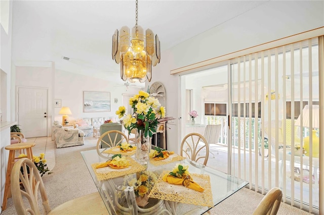 dining space with carpet and an inviting chandelier