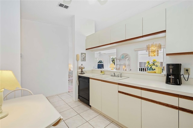 kitchen featuring visible vents, white cabinets, light countertops, light tile patterned floors, and dishwasher