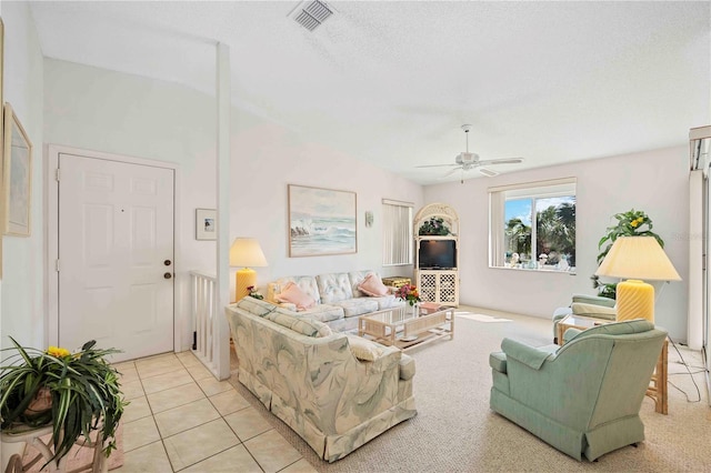 living room with light tile patterned floors, visible vents, and a ceiling fan