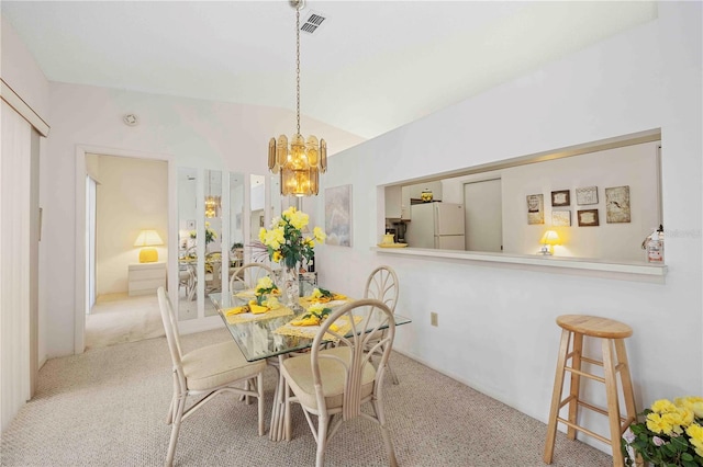 dining space featuring carpet and a chandelier