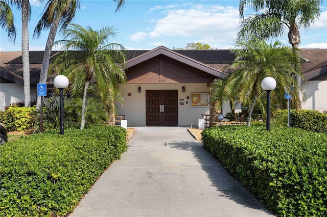 view of front of house featuring stucco siding, driveway, and an attached garage