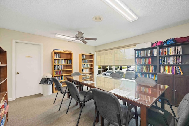 office with ceiling fan, carpet, and a textured ceiling