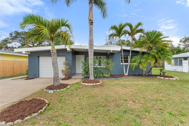 mid-century inspired home with a garage, a front yard, concrete driveway, and stucco siding