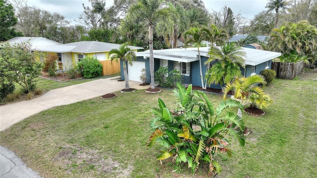 ranch-style house with a front lawn, concrete driveway, fence, and an attached garage