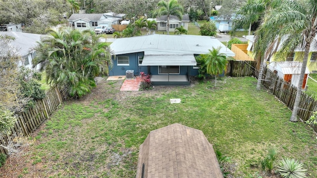 view of yard featuring a fenced backyard, a patio, and central air condition unit