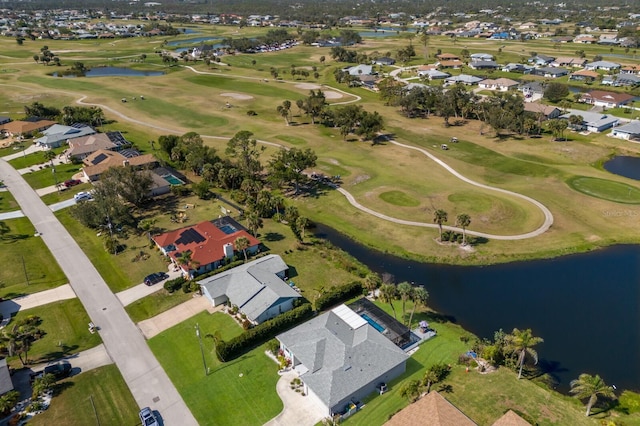 drone / aerial view with a water view, a residential view, and golf course view