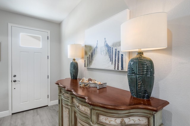 entrance foyer featuring baseboards and wood finished floors