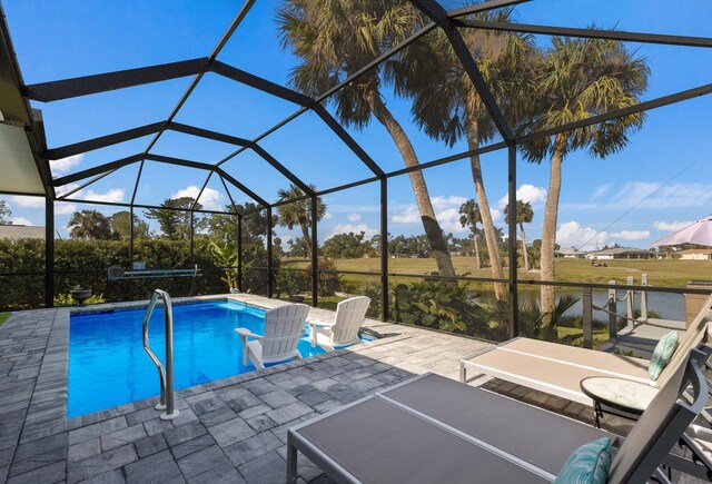 pool with a lanai and a patio area