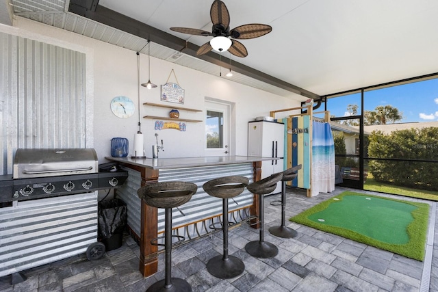 view of patio featuring outdoor dry bar and grilling area