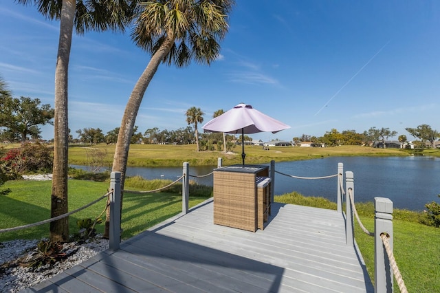 dock area featuring a water view and a lawn