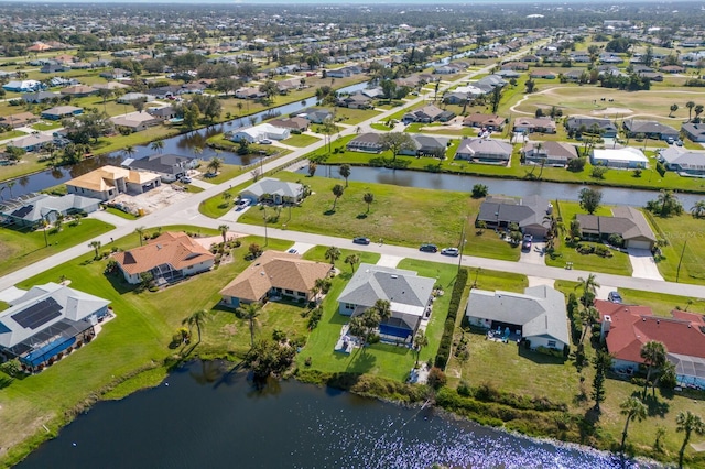 birds eye view of property with a water view and a residential view