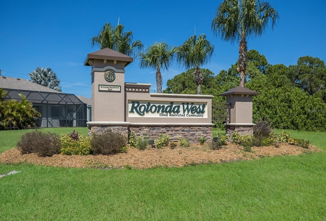 community / neighborhood sign with a lawn