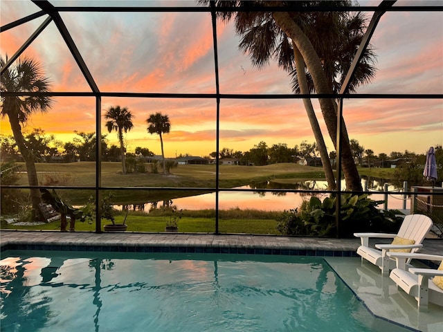 outdoor pool featuring a lanai, a patio area, and a water view