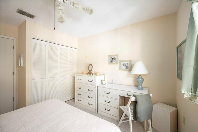 bedroom featuring a closet, visible vents, light carpet, and ceiling fan