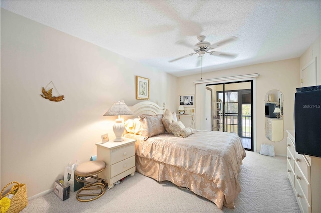 bedroom with a textured ceiling, access to outside, a ceiling fan, and light carpet