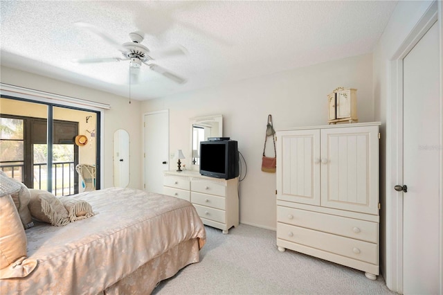 bedroom featuring light carpet, a textured ceiling, ceiling fan, and access to outside