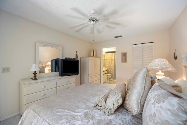 bedroom with visible vents, carpet floors, ensuite bath, ceiling fan, and a closet