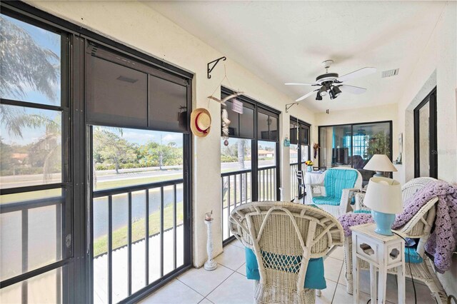 sunroom / solarium with visible vents and ceiling fan