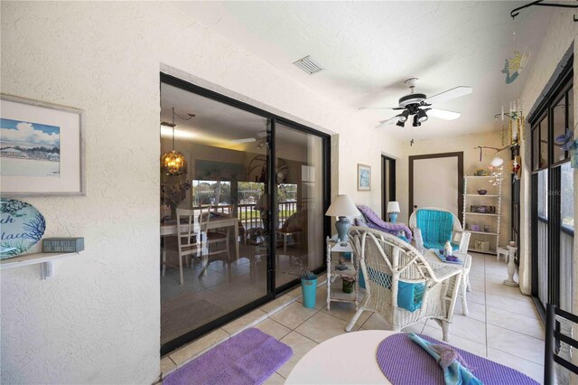 sunroom / solarium with visible vents and ceiling fan