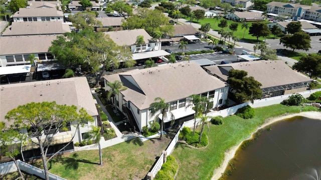 birds eye view of property with a residential view and a water view