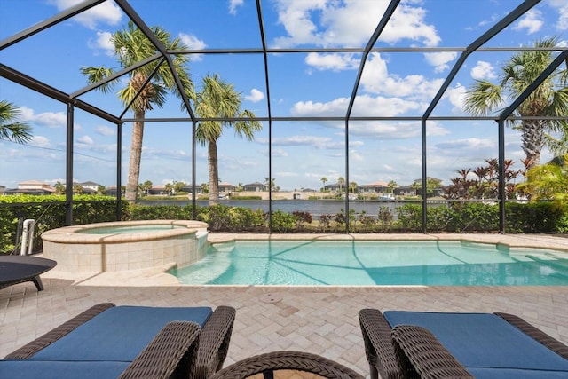 view of swimming pool featuring a lanai, a water view, a pool with connected hot tub, and a patio