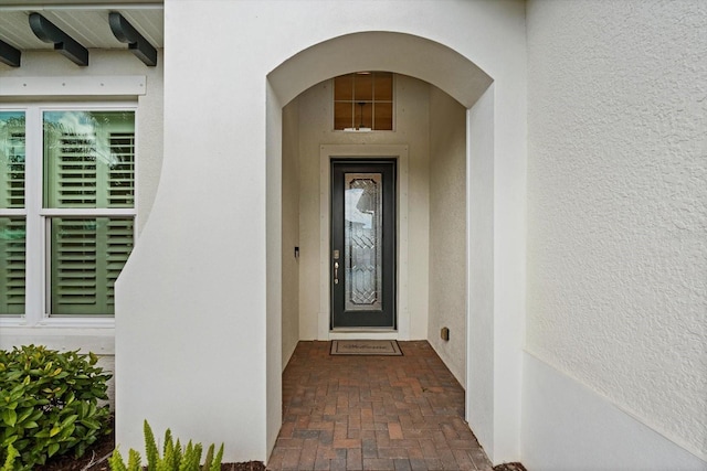 property entrance with stucco siding