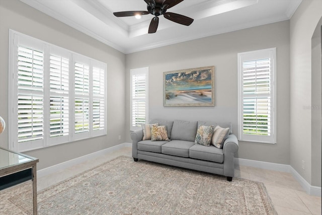 interior space with a tray ceiling, a wealth of natural light, and ornamental molding