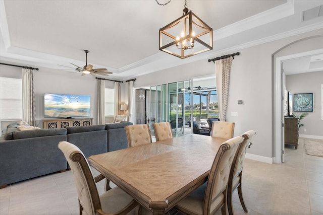 dining area featuring ornamental molding, a raised ceiling, and visible vents