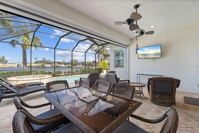 view of patio / terrace with an outdoor pool, glass enclosure, ceiling fan, an in ground hot tub, and outdoor dining area