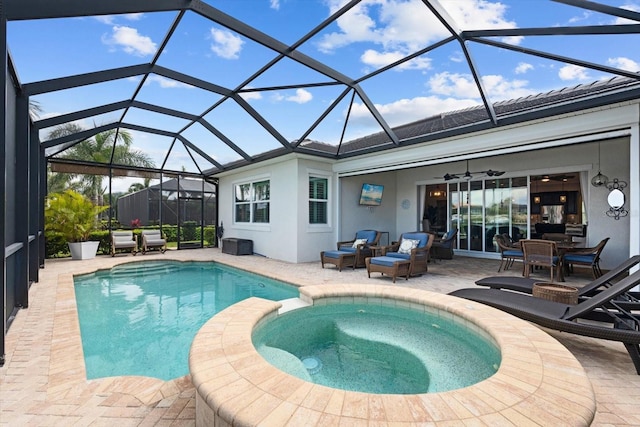 view of swimming pool featuring a pool with connected hot tub, a patio, and ceiling fan