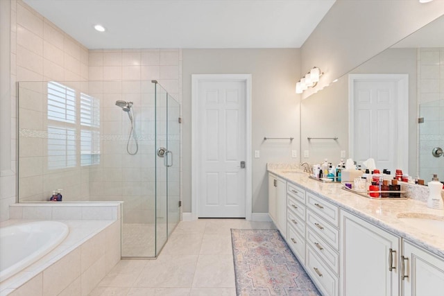 bathroom featuring a bath, a stall shower, double vanity, and a sink