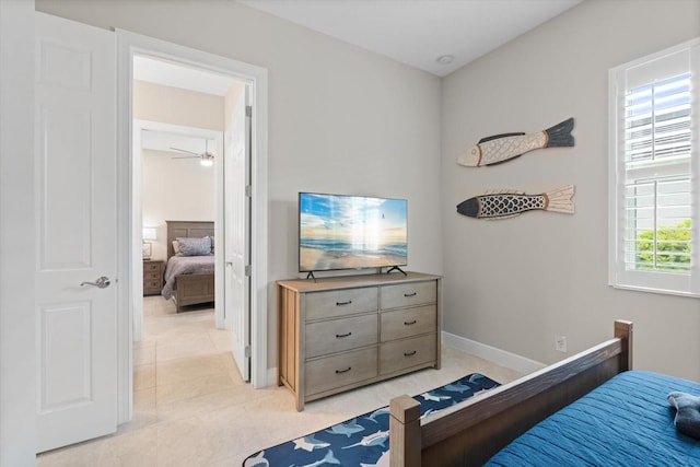 bedroom featuring light tile patterned floors and baseboards