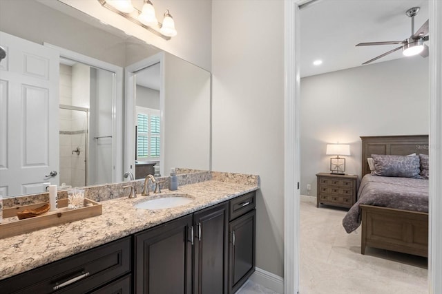 full bath with a stall shower, baseboards, a ceiling fan, ensuite bathroom, and vanity