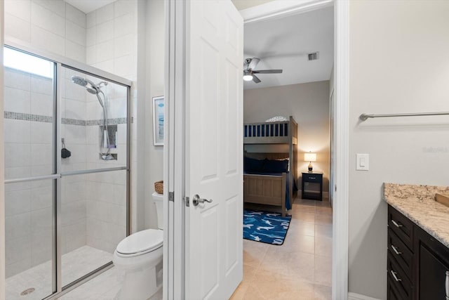 ensuite bathroom featuring toilet, a stall shower, ensuite bath, and vanity