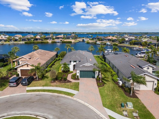 drone / aerial view featuring a residential view and a water view