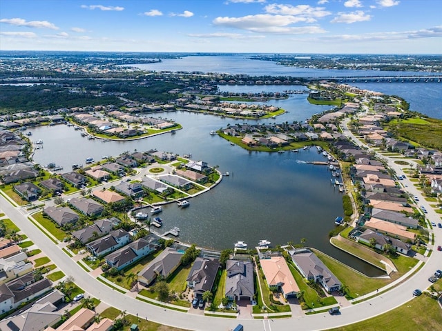 drone / aerial view with a water view and a residential view