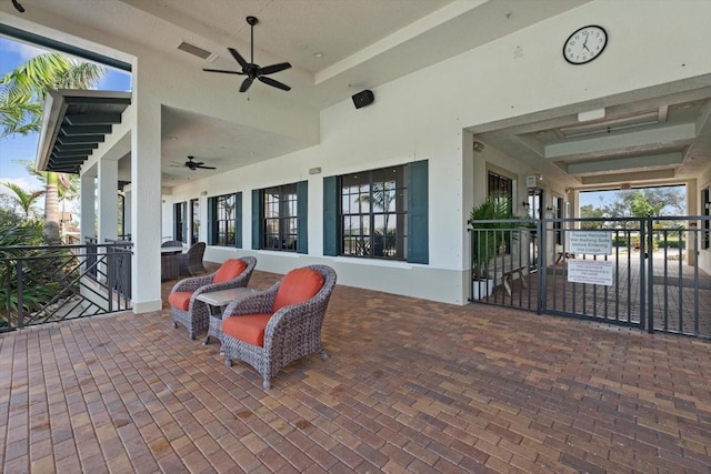 view of patio with ceiling fan and visible vents