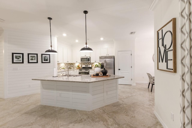 kitchen featuring a large island, visible vents, appliances with stainless steel finishes, white cabinetry, and a sink