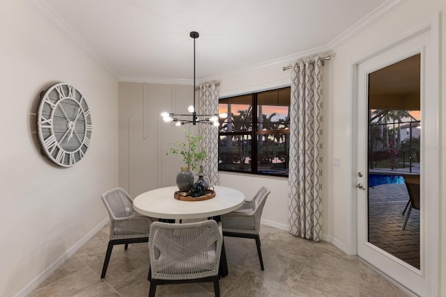 tiled dining area with baseboards, ornamental molding, plenty of natural light, and an inviting chandelier